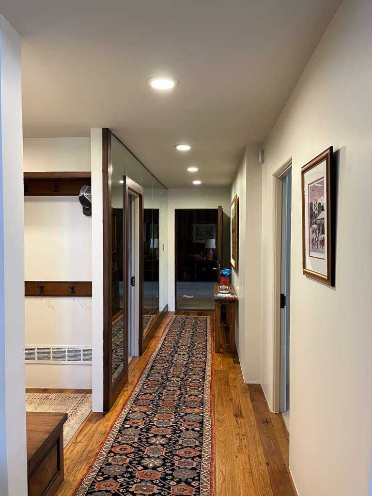 Mudroom with deep olive green cabinet painting and matching shiplap walls