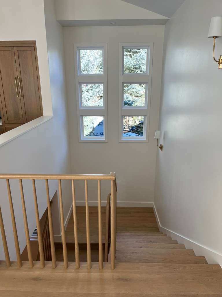 Living room with painted vaulted ceiling and arched window trim